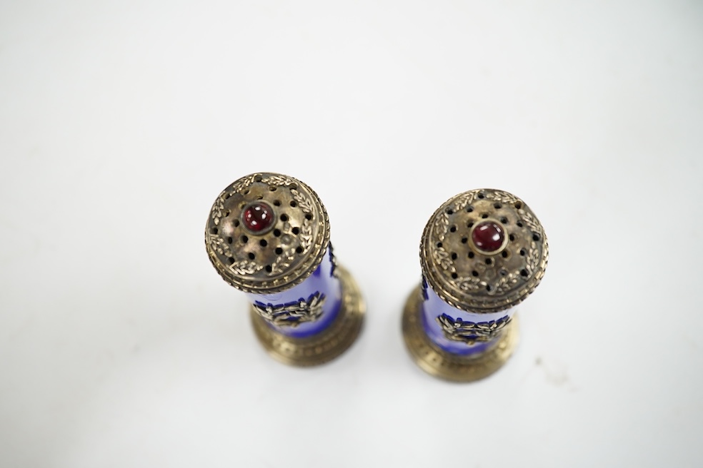 A cased pair of Russian style white metal and enamel cylindrical pedestal pepperettes, 10cm, enamel a.f. Condition - poor